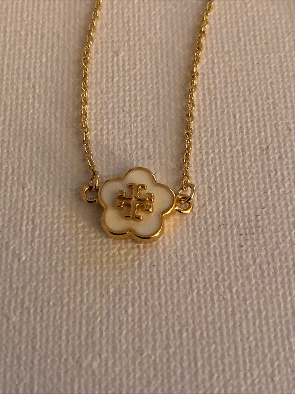 Tory Burch Gold Tone Bracelet with White Enamel Flower Charm